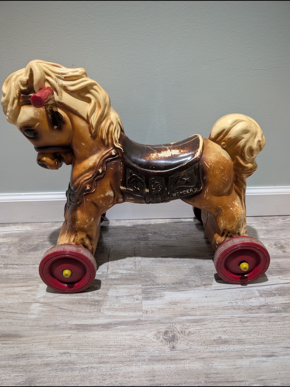 Vintage Yellow Ride-On Pony Toy with Red Wheels